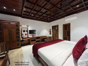 a bedroom with a bed and a vanity and a mirror at Cherai Beach view Heritage in Pallipuram