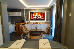 a room with a kitchen and a table with chairs at Hotel Bijoux in Plaridel