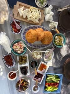 a table topped with plates of food and bowls of food at Çakir Bey Hotel in Alaçatı +66 photos