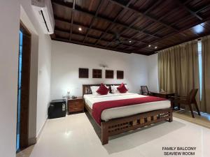 a bedroom with a large bed with red pillows at Cherai Beach view Heritage in Pallipuram +19 photos