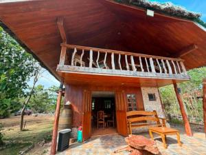 a small house with a porch and a balcony at Sunset Haven in Siquijor +4 photos