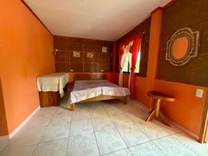 a room with two beds and a window in it at Sunset Haven in Siquijor