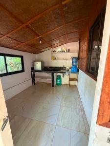 an empty room with a kitchen in a house at Sunset Haven in Siquijor