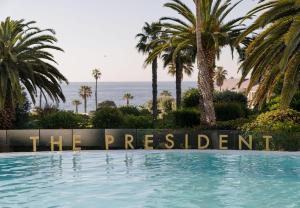 a swimming pool with a sign that reads the resort at President Hotel in Cape Town