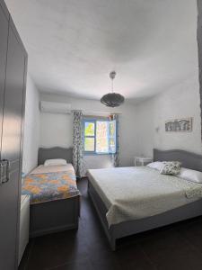 a bedroom with two beds and a window at Çakir Bey Hotel in Alaçatı