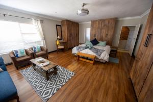 a living room with a couch and a table at Colchester Suites - Travel Addo Group in Cannonvale +13 photos