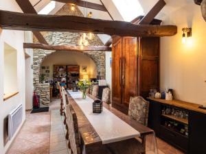 a dining room with a long table and chairs at Escapade Bretonne in Lannion