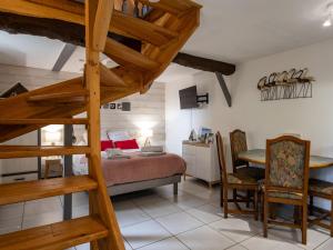 a bedroom with a bed and a staircase in a room at Escapade Bretonne in Lannion