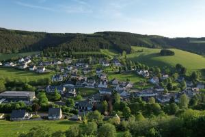 an aerial view of a small village in the hills at Ferienwohnung bei Karl in Schmallenberg