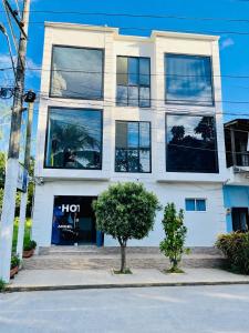 a tall white building with a lot of windows at Angel Mari a Doradal in Doradal