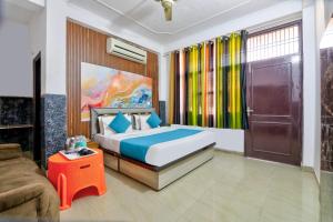 a bedroom with a bed and a couch at Hotel Radha Rani Bhawan in Vrindāvan
