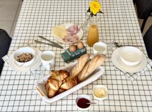 a table with a plate of bread and eggs on it at B&B Le Chardon in Saint-Gervais-les-Trois-Clochers