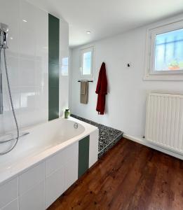 a bathroom with a large tub and a window at B&B Le Chardon in Saint-Gervais-les-Trois-Clochers
