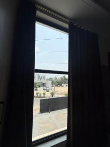 a window with a view of a parking lot at Hotel sky inn in Jalandhar