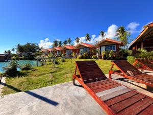 a row of houses with a bench in front of it at Panglima Resort Bum Bum Island, Semporna in Semporna