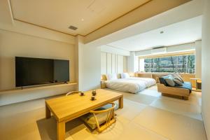 a large living room with a bed and a tv at Zazan minakami in Minakami