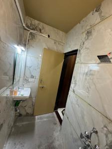 a bathroom with a sink and a shower at Ramona homestay in Kolhapur