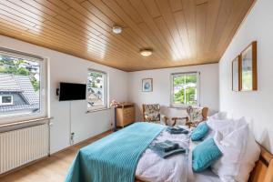 a bedroom with a bed with a wooden ceiling at Auszeit im Grünen in Bad Schwalbach
