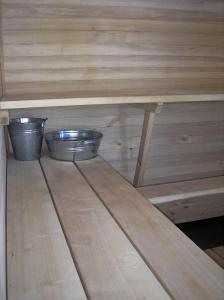 two metal bowls sitting on top of a wooden table at Kempings Ozolkalns in Cēsis