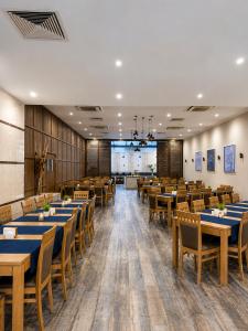 a dining room with wooden tables and chairs at Vitosha Park Hotel - Free Pool & Gym in Sofia