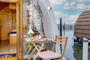 a table and a chair on a boat at Hausboot Dotterbart in Stralsund +19 photos
