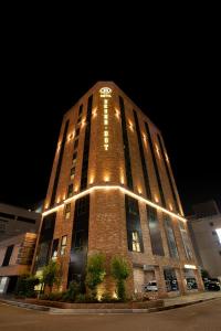 a tall brick building with lights on it at night at Brown Dot Hotel Ulsan Samsan in Ulsan