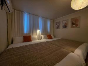 a bedroom with a large bed in front of a window at 스테이 온기 in Suwon