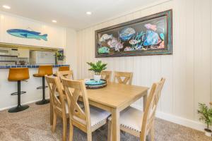 a dining room with a wooden table and chairs at C4 - Coastal Cottage in Oceanside