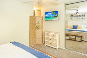 a bedroom with a bed and a mirror at C4 - Coastal Cottage in Oceanside