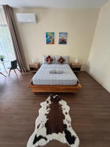 a bedroom with a bed with a black and white rug at Lucia’s Place in Tanauan