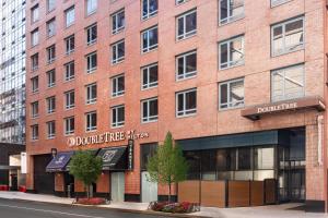 a red brick building with a sign on it at Doubletree By Hilton New York Times Square West in New York
