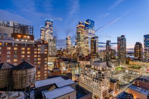 a city skyline at night with tall buildings at Doubletree By Hilton New York Times Square West in New York