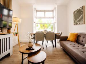 a living room with a couch and a table at Groups Haven 5 Bed 2 Bath Hot Tub Pool Table in Attercliffe