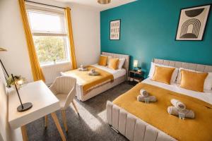 a bedroom with two beds and a table and a desk at Groups Haven 5 Bed 2 Bath Hot Tub Pool Table in Attercliffe