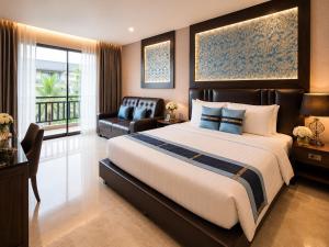 a large bedroom with a large bed and a chair at Aranta Suvarnabhumi in Lat Krabang
