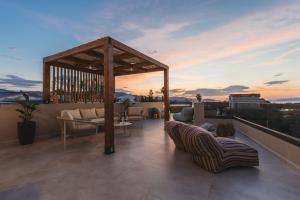 a rooftop patio with couches and a gazebo at Ark Luxury Suite, Hot tub & Sea Views, by ZanteWize in Tragaki
