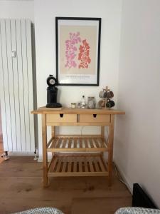 a wooden table in a room with a picture on the wall at Schöne Wohnung in Passau in Passau