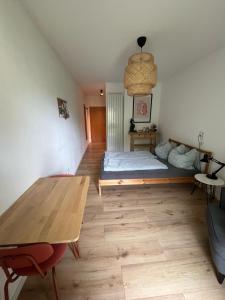 a room with a bed and a wooden table at Schöne Wohnung in Passau in Passau