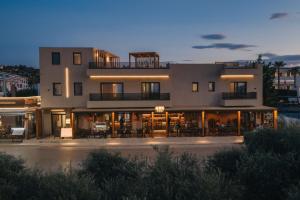 a large building with tables and chairs in front of it at Ark Luxury Suite, Hot tub & Sea Views, by ZanteWize in Tragaki