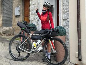 a woman is standing next to a bike at B&B La Dolce Sosta in Fonni