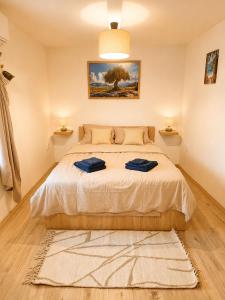 a bedroom with a bed with two towels on it at Sky Terrace retreat in Draga Bašćanska