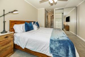 a bedroom with a large bed with blue pillows at B205 - Ocean Escape in Oceanside +57 photos