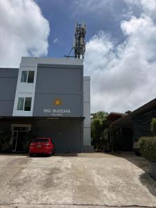 a red car parked in front of a building at Big Buddha Hillside Hotel in Phuket +29 photos