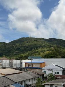 a mountain in the distance with buildings and trees at Big Buddha Hillside Hotel in Phuket