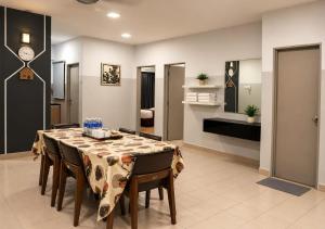 a dining room with a table and chairs at Alami Garden Hotel in Shah Alam