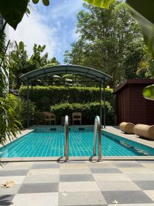 a swimming pool with a cover over it at Big Buddha Hillside Hotel in Phuket