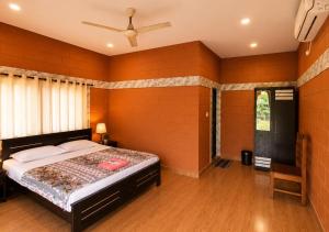 a bedroom with a large bed in a room at Sheen Villa Homestay in Varkala