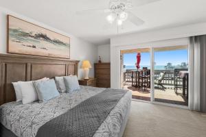 a bedroom with a bed and a view of the ocean at A304 - Sail Away Stay in Oceanside +59 photos