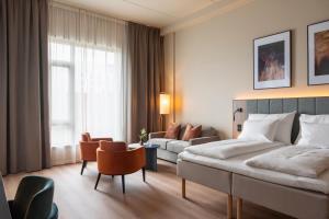 a hotel room with a bed and a couch at Thon Hotel Drammen in Drammen