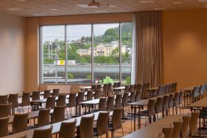 a room with tables and chairs and a large window at Thon Hotel Drammen in Drammen